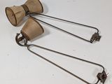 pair of antique wooden lamps with metal handles on a white surface