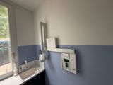 a bathroom with a sink, mirror, and a window