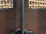 a close up of a wooden fence with a metal latch on it