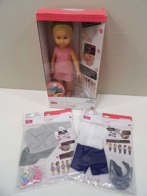 doll in a box with clothing and accessories on a table