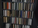 a book shelf with many books on it in a room