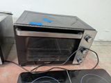 an image of a toaster oven sitting on the floor