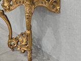 a gold console table with a marble top in a room