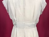 a white blouse on a mannequin stand against a red background