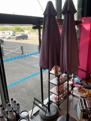 two umbrellas that are sitting on a table in front of a window