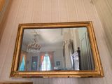 a mirror hanging on the wall in a room
