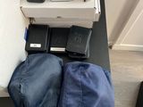 Plusieurs téléphones portables sont posés sur une table, à côté d'un sac.