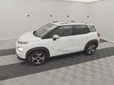 a picture of a white citrole parked in a garage