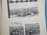 an open book with a picture of a city in the middle of it