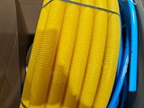 a box with a bunch of yellow hoses inside of it