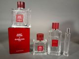 two bottles of perfume sitting next to each other on a table