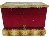a small red box with a picture on top of it