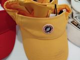 many hats that are sitting on a table