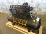 an air compressor sitting on top of a wooden pallet next to a wall