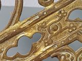 a close up view of a gold metal gate