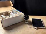 a box with a solar panel and a cell phone on a table