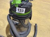a vacuum that is sitting on the floor next to some tools