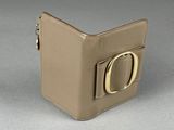 beige leather wallet with a gold d on the front of it
