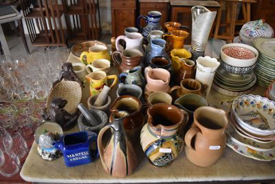 many different types of vases and bowls on the table