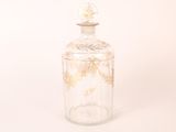 a glass bottle with a gold leaf design on it