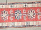 rug on the floor is red and blue with a pattern on it