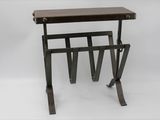 a small table with a magazine rack on top of it