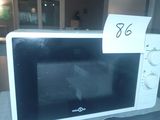 a microwave with a price tag on it sitting on a counter