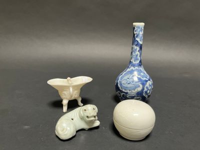 three small vases and a ball on a table
