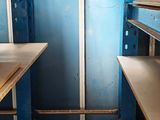 a small room with shelves and a door in it