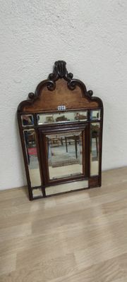 a small mirror sitting on the floor next to a fireplace