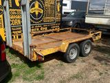 a truck with a trailer attached to it in a field