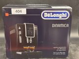 the box of the delonghi coffee machine is open on the table