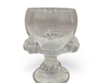 a clear glass cup with a flower on the base