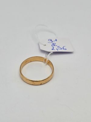 gros plan d'une bague sur une surface blanche avec une étiquette de prix