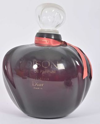 an image of a bottle of perfume on a white surface