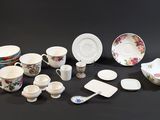 many different types of dishes and cups on the table