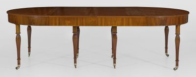 an oval dining table with two legs and a wooden top