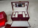 a red box with a mirror and jewelry inside of it
