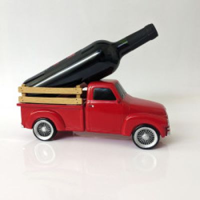 a red truck with a bottle of wine in the back