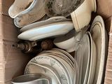 a cardboard box full of plates and bowls in it