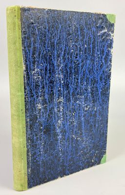 a blue and green book sitting on top of a white surface