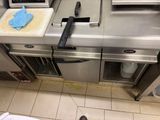 a person standing in front of a kitchen counter with a knife and a cutting board