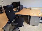 a desk with two computer monitors on it and a chair in front of it