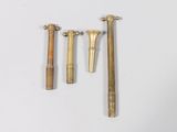 three different types of brass screws and a hammer on a white surface
