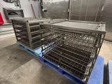 a large metal cage on a pallet in a kitchen
