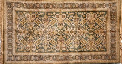 an antique rug with a floral design on a white background