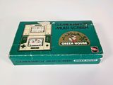 a green box with a game on it on a white surface