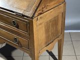 a small wooden desk with a drawer on top of it