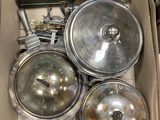 a box full of silver pots and pans in it