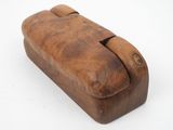 an old wooden box with a handle on a white surface